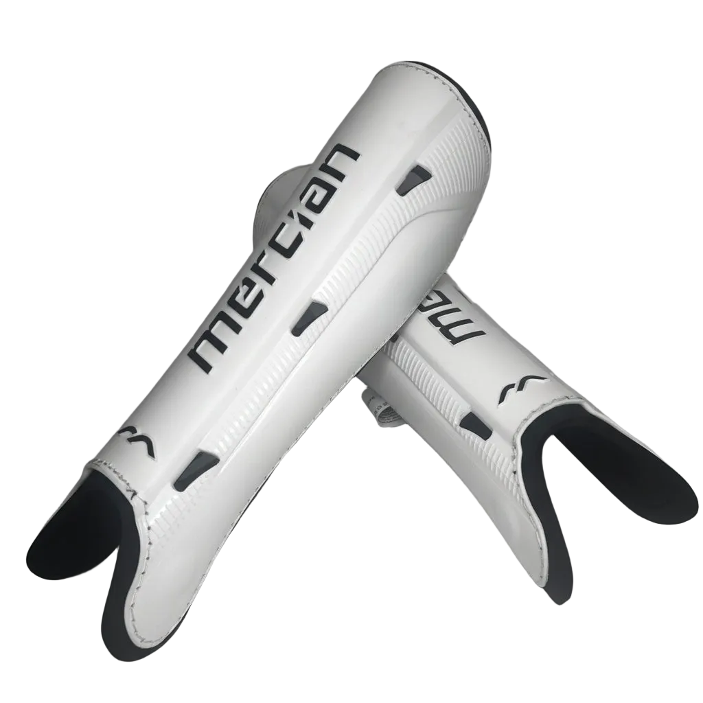 A pair of white shin guards with black accents and the brand name 'mercian' printed in black on the side, set against a plain white background.