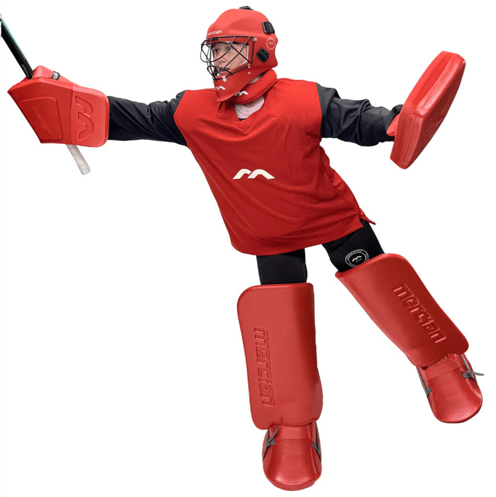 Person wearing a red field hockey protective gear set on a white background