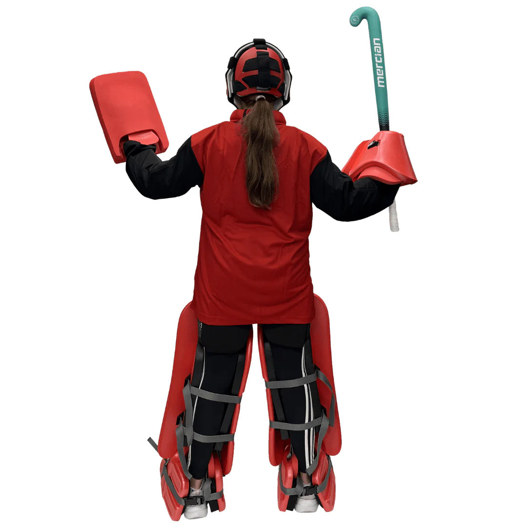 Person wearing a red field hockey goalie outfit with protective gear on a white background