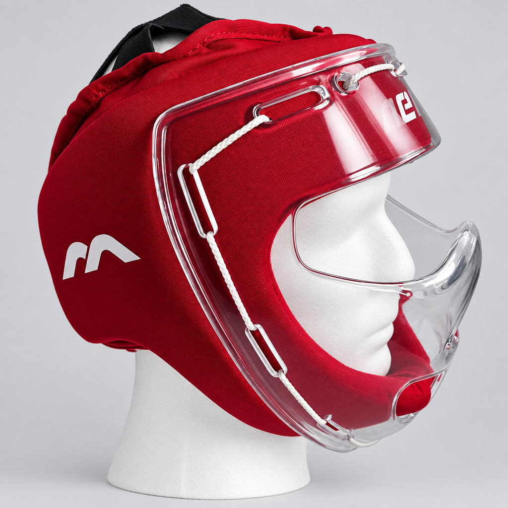 A red field hockey headguard with a clear plastic face shield and chin guard, displayed on a white mannequin head against a light gray background.