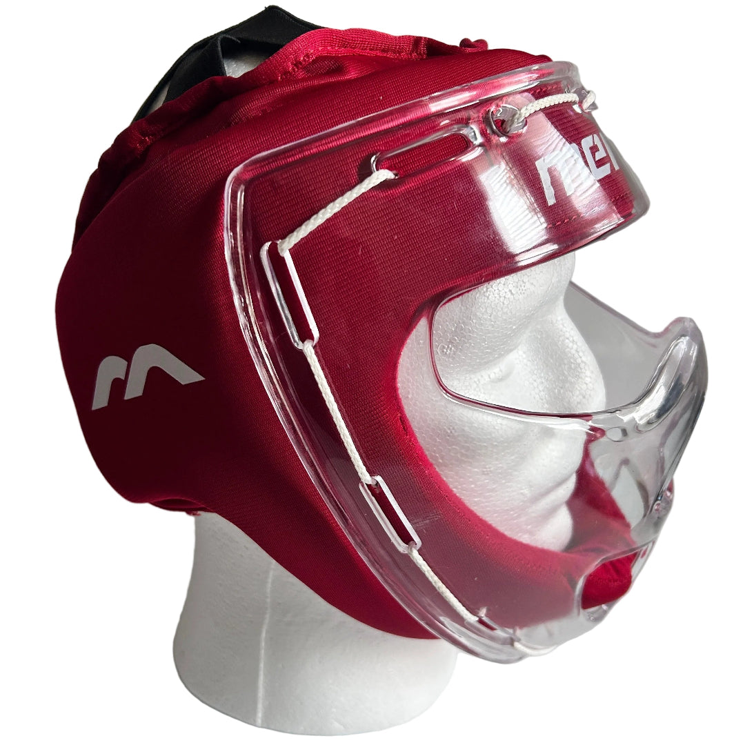 A red field hockey headguard with a clear plastic face shield and chin guard, displayed on a white mannequin head against a light gray background.