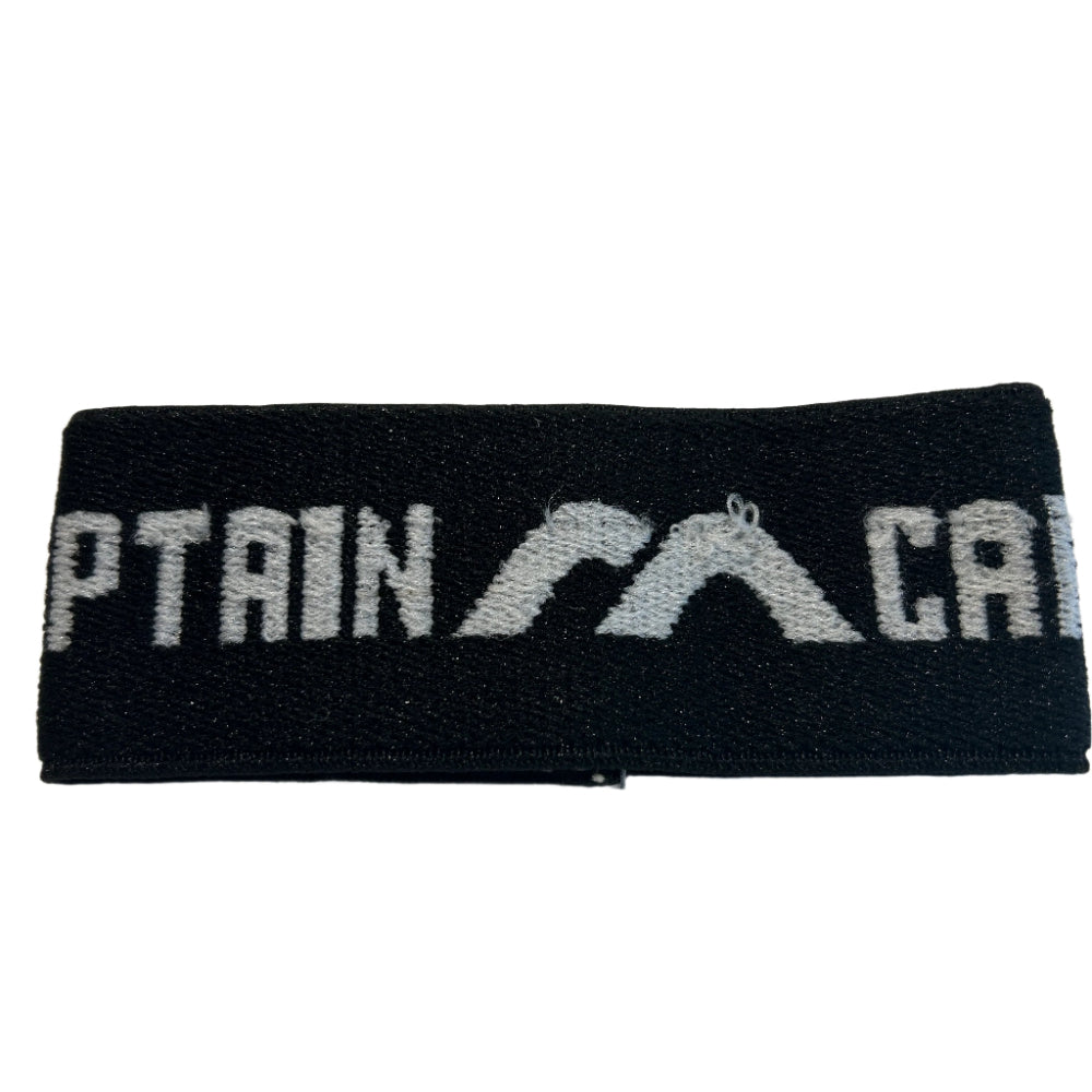 Black captains arm band with 'CAPTAIN' and a logo on a white background