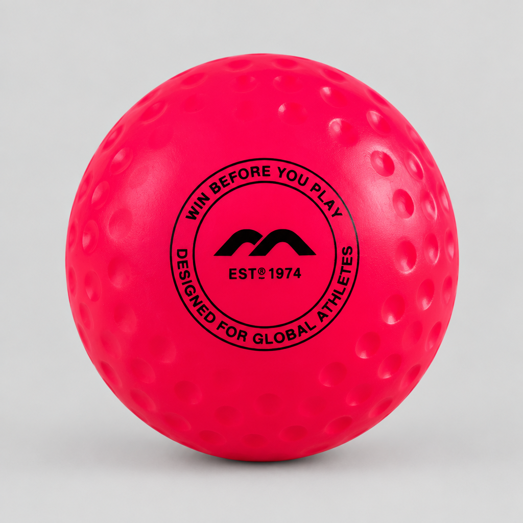 Large pink dimpled field hockey ball on a light grey background