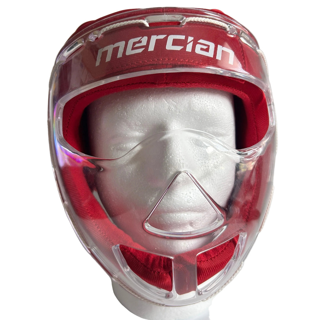 A red Mercian hockey faceguard with a clear plastic visor and chin guard, displayed on a white mannequin head against a white background.