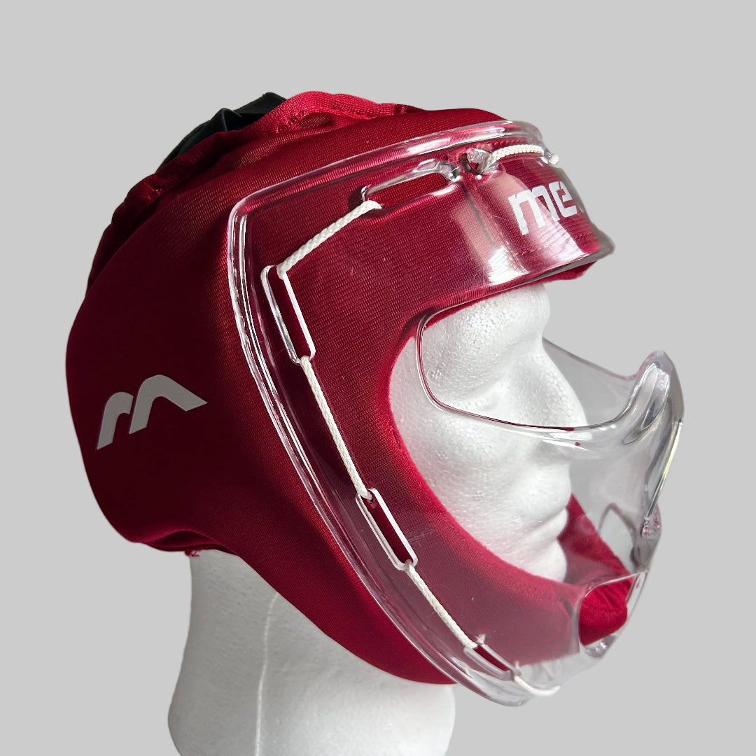 A red hockey-style protective headguard with a clear face shield and white chin bar, displayed on a white mannequin head against a light gray background.