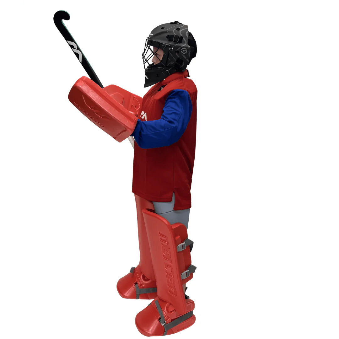 Person wearing red field hockey goalkeeper gear and a black helmet on a white background